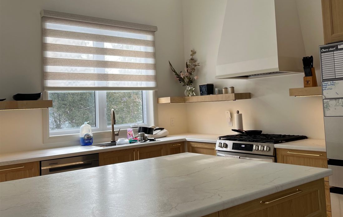 Chantel's kitchen: a wood-and-marble island, dishes by the sink, a chore chart on the fridge